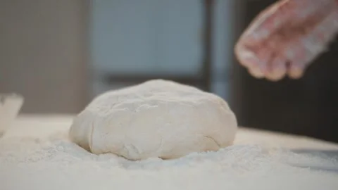 Kneading fresh dough with flour falling around Stock Footage 336047418