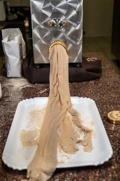 Kneading machine while outputting dough Stock Photos