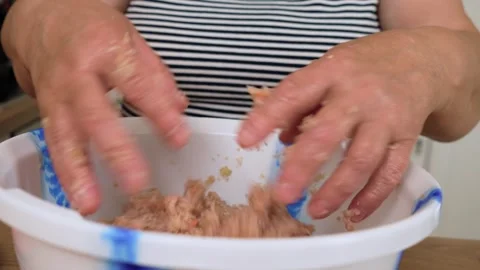 Kneading minced meat with both hands in bowl. Unrecognizable person mixing Stock Footage 318241637