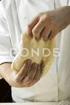 Kneading pizza dough Stock Photos