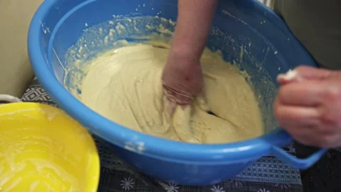 Kneading Raw Dough by Hand in a Large Blue Plastic Basin Stock Footage 332732632