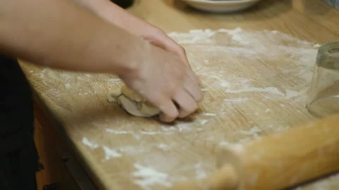 Kneading raw flour dough with hands on kitchen table Stock Footage 340078110
