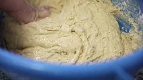 Kneading Smooth and Elastic Dough by Hand in a Large Blue Bowl Stock Footage 332735308