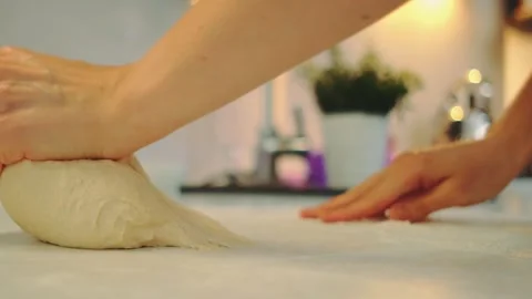 Kneading yeast dough with hands on the kitchen table Stock Footage 252432946