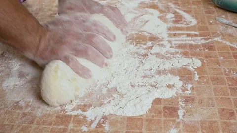 Kneads the dough with his hands on the table hd Video stock 80041396