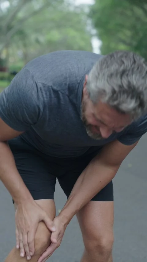 Knee joint dislocation after running. Sport injury. Arthritis. Man massage knee Stock Footage 326354666