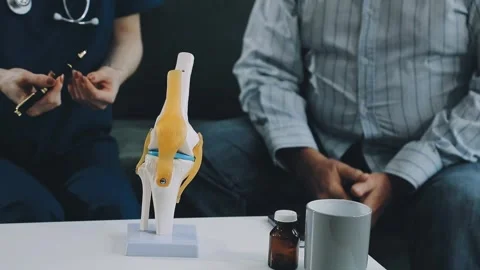 Knee model showing the process of osteoarthritis and knee arthroplasty, doc.. Stock Footage 314212319