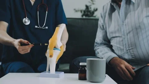 Knee model showing the process of osteoarthritis and knee arthroplasty, doc.. Stock Footage 314212320