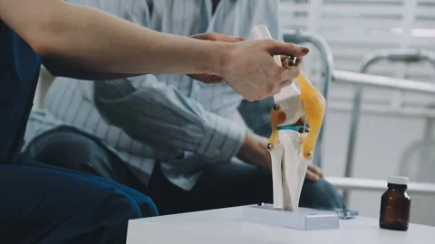 Knee model showing the process of osteoarthritis and knee arthroplasty, doc.. Stock Footage 314212322