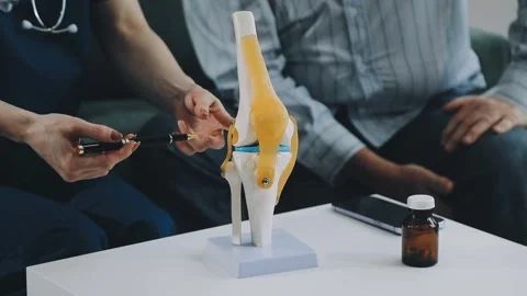 Knee model showing the process of osteoarthritis and knee arthroplasty, doc.. Stock Footage 314212323