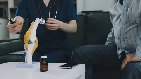 Knee model showing the process of osteoarthritis and knee arthroplasty, doc.. Stock Footage 314212330