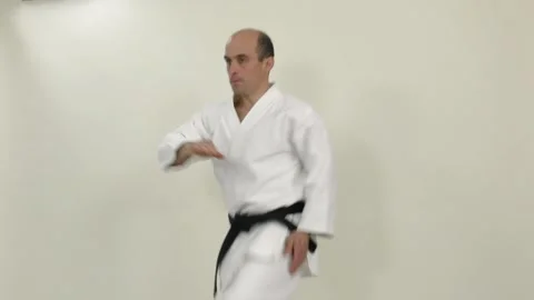 Knee strikes on the hand in a jump are performed by an athlete in karategi Stock Footage 246983722