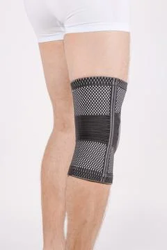 Knee Support Brace on leg isolated on white background. Elastic orthopedic Stock Photos