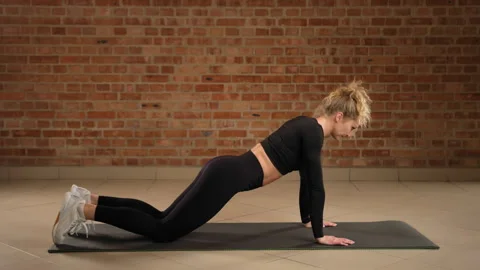 Kneeling High Plank Pose for Core Engagement and Stability in Modern Fitness Stock Footage 269199440