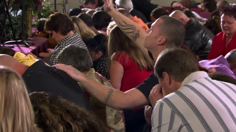 Kneeling, praying congregation seen from rear at an angle Stock Footage 59532096