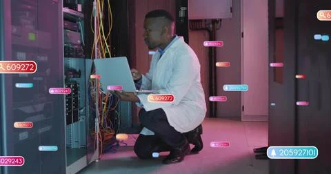 Kneeling tech in white lab coat inspecting rack in server room, laptop, cables, Stock Photos