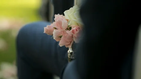 Knees and legs in church wedding aisle with pink and white flower vase Stock Footage