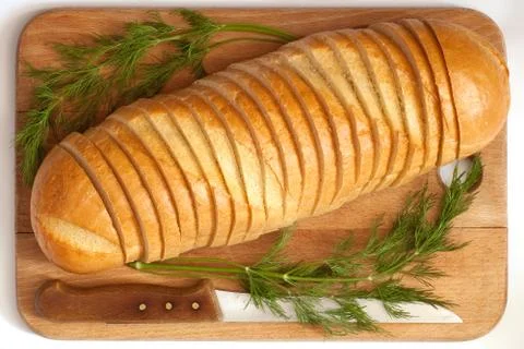 Knife and bread on a board Stock Photos