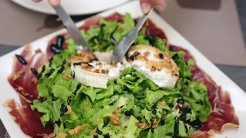 Knife and Fork Delights: Close-Up of a Tasty Salad Stock Footage 247257495