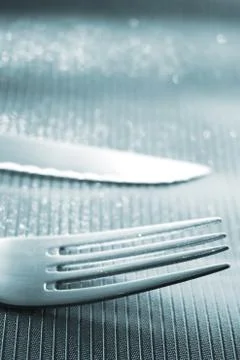 Knife and fork on dinner table Stock Photos