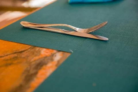 Knife and fork on an empty table Stock Photos