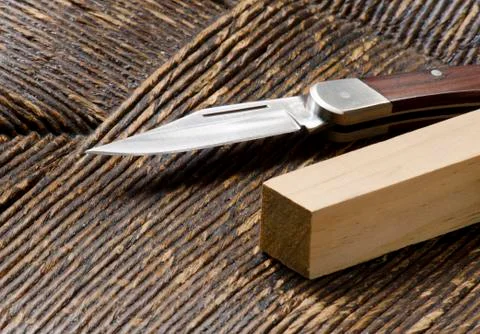 Knife and square peg Stock Photos