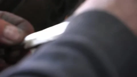 Knife blacksmith working in his knife workshop. Stock Footage 195726328