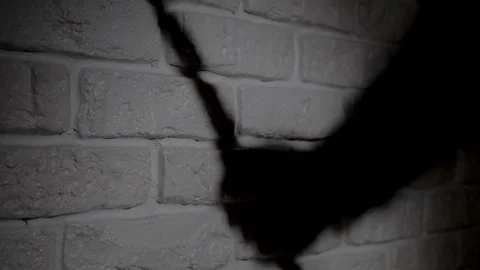 Knife is crawling in night. Shadow reflection of a hand with a knife on the wall Video stock 124018655