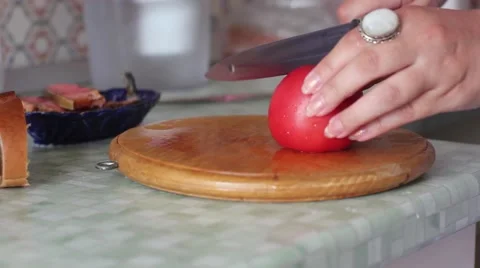 With a knife cut a tomato Video stock 65391581