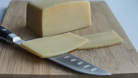 Knife cut two slices of cheese from square piece of cheese Stock-Footage 152485752