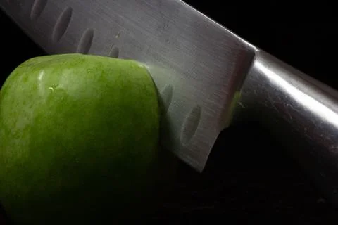 Knife cuts apple Stock Photos