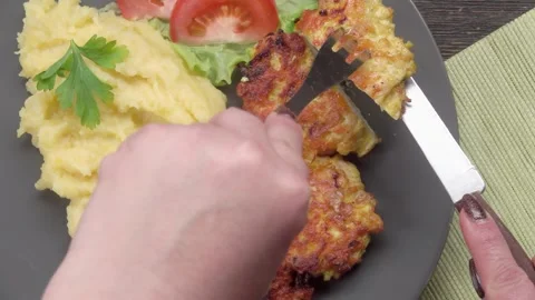 Knife cuts crispy chicken cutlet with crust Stock Footage 296581967