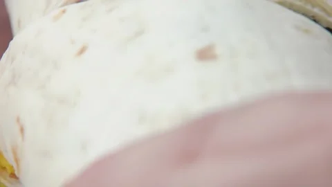 A knife cuts a delicious burrito in half Stock Footage 294892008