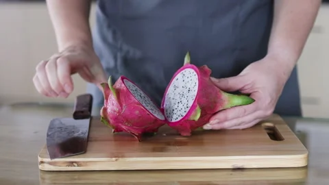 Knife cuts dragon fruit in half. Stock Footage 291613823