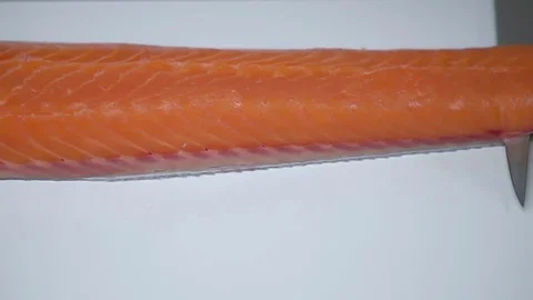 The knife cuts the fillets of red salmon fish. Stock Footage 77722649