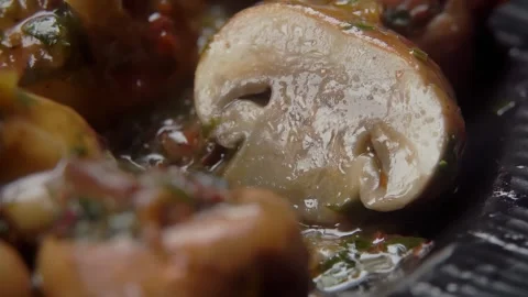 A knife cuts a fried champignon in half Stock Footage 296581566
