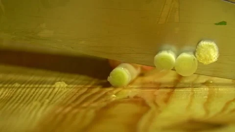 Knife cuts the green onion in kitchen on wooden board. Close up. Stock Footage 231897277