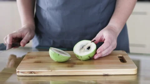 Knife cuts green star apple in half. Video stock 291614756