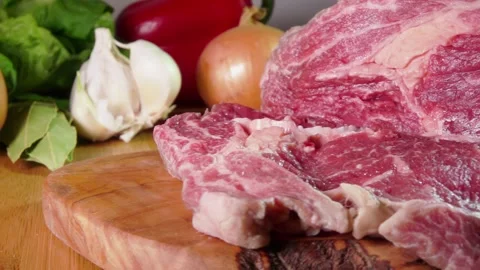 Knife cuts marbled beef steak on a wooden board slow motion Stock Footage 302109259