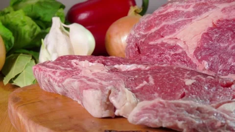 Knife cuts marbled beef steak on a wooden board slow motion Stock Footage 314376762