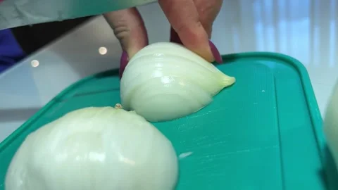 Knife cuts onion on the table into slices Stock Footage 221271276