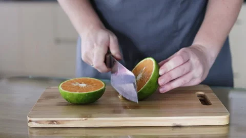 Knife cuts orange in half. Stock Footage 291766234