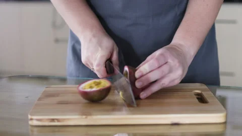 Knife cuts passion fruit in half. Stock Footage 291612442