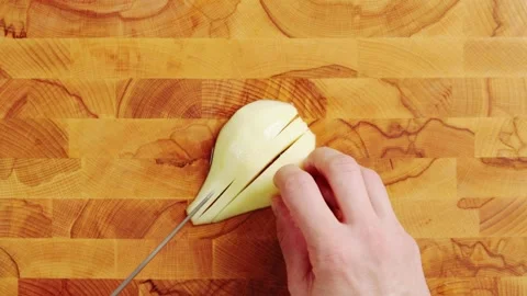 Knife cuts pear half into thin slices, close up. Video stock 344769778