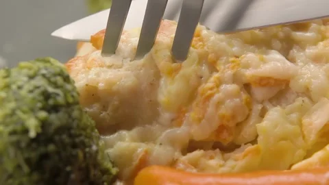 A knife cuts a piece of fried white fish fillet Stock Footage 306461645