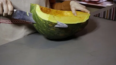 Knife cuts a pumpkin into pieces Stock Footage 76983878