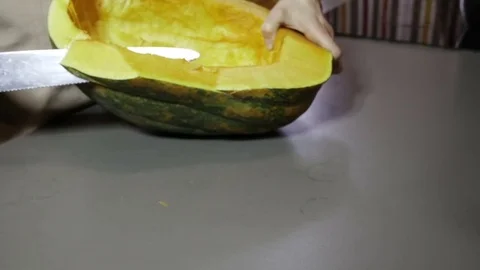 Knife cuts a pumpkin slow motion Stock Footage 76979088