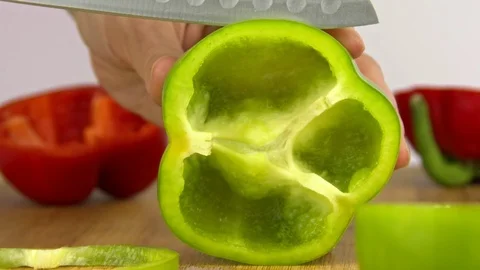 The knife cuts off a ring of green pepper Stock Footage 83629914