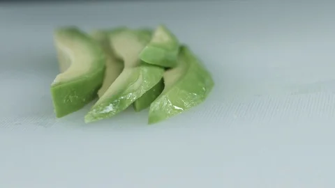 The knife cuts a ripe avocado Stock Footage 80595122