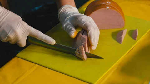 Knife cuts the sausage Close up Stock Footage 119702774